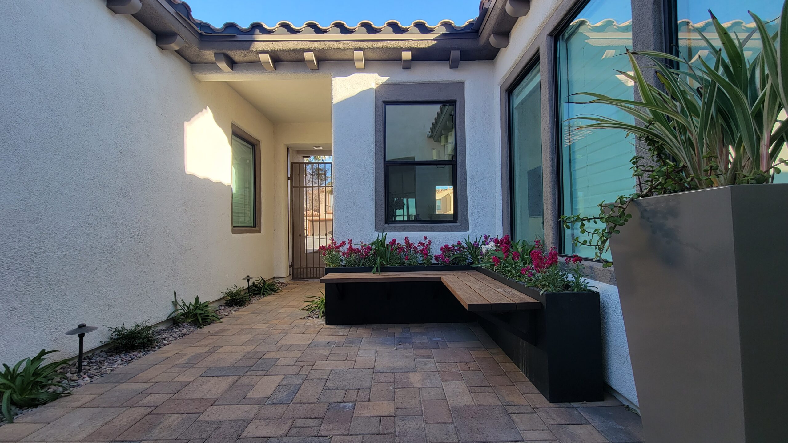 A bench sitting in the middle of a patio. A bench sitting in the middle of a patio.
