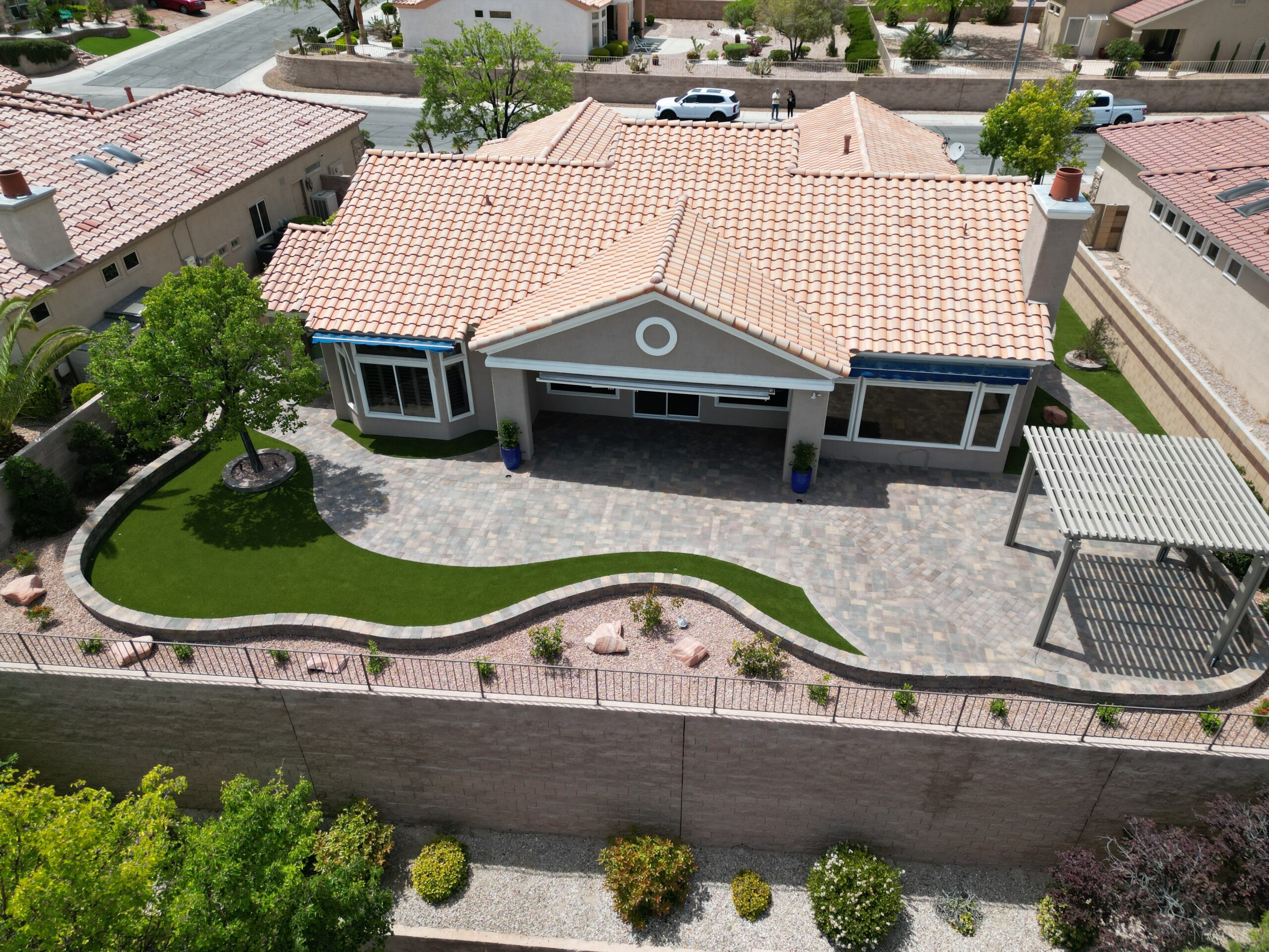 A house with a driveway and patio area. A house with a driveway and patio area.