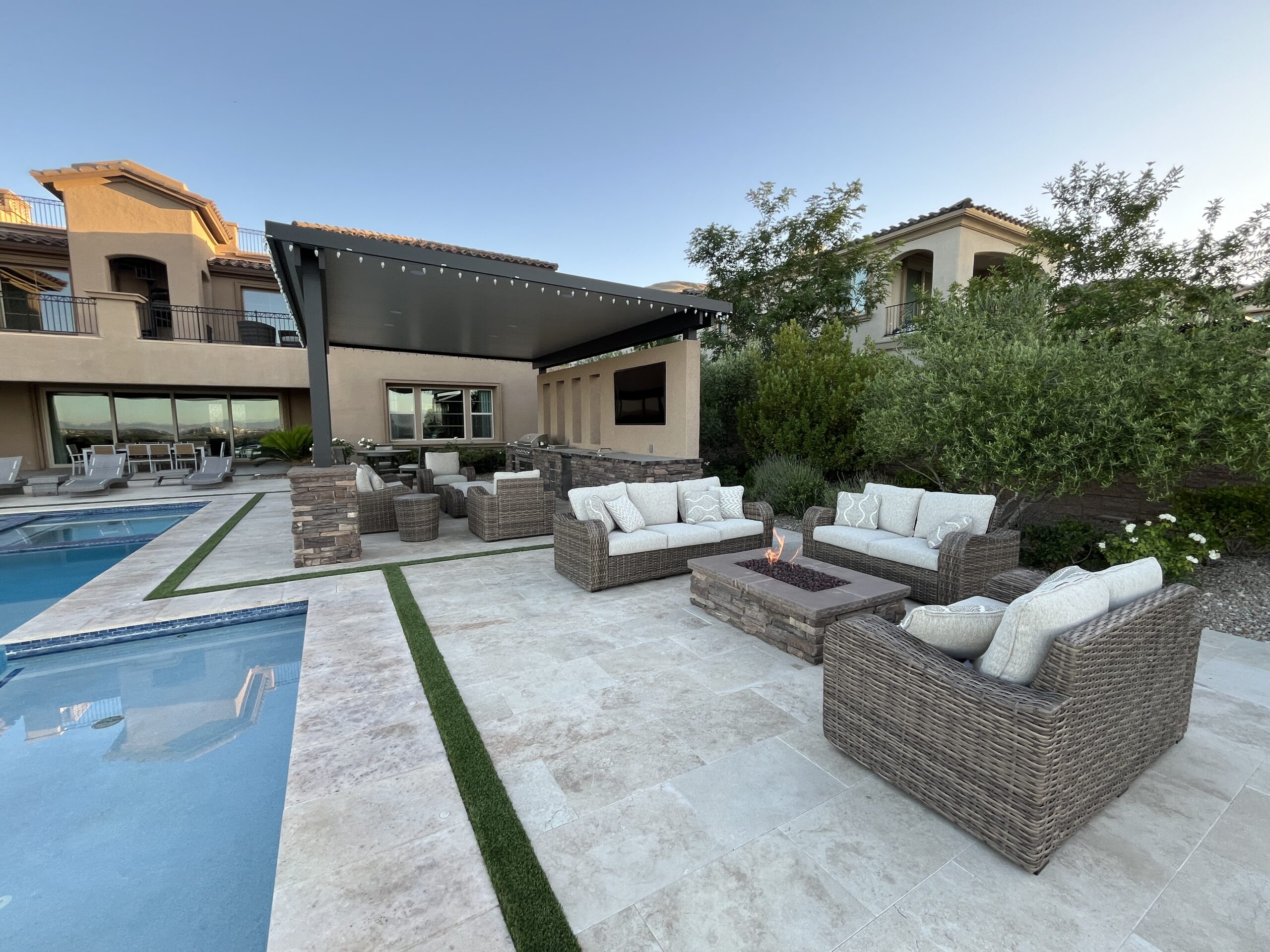A large backyard with a pool and patio furniture. A large backyard with a pool and patio furniture.