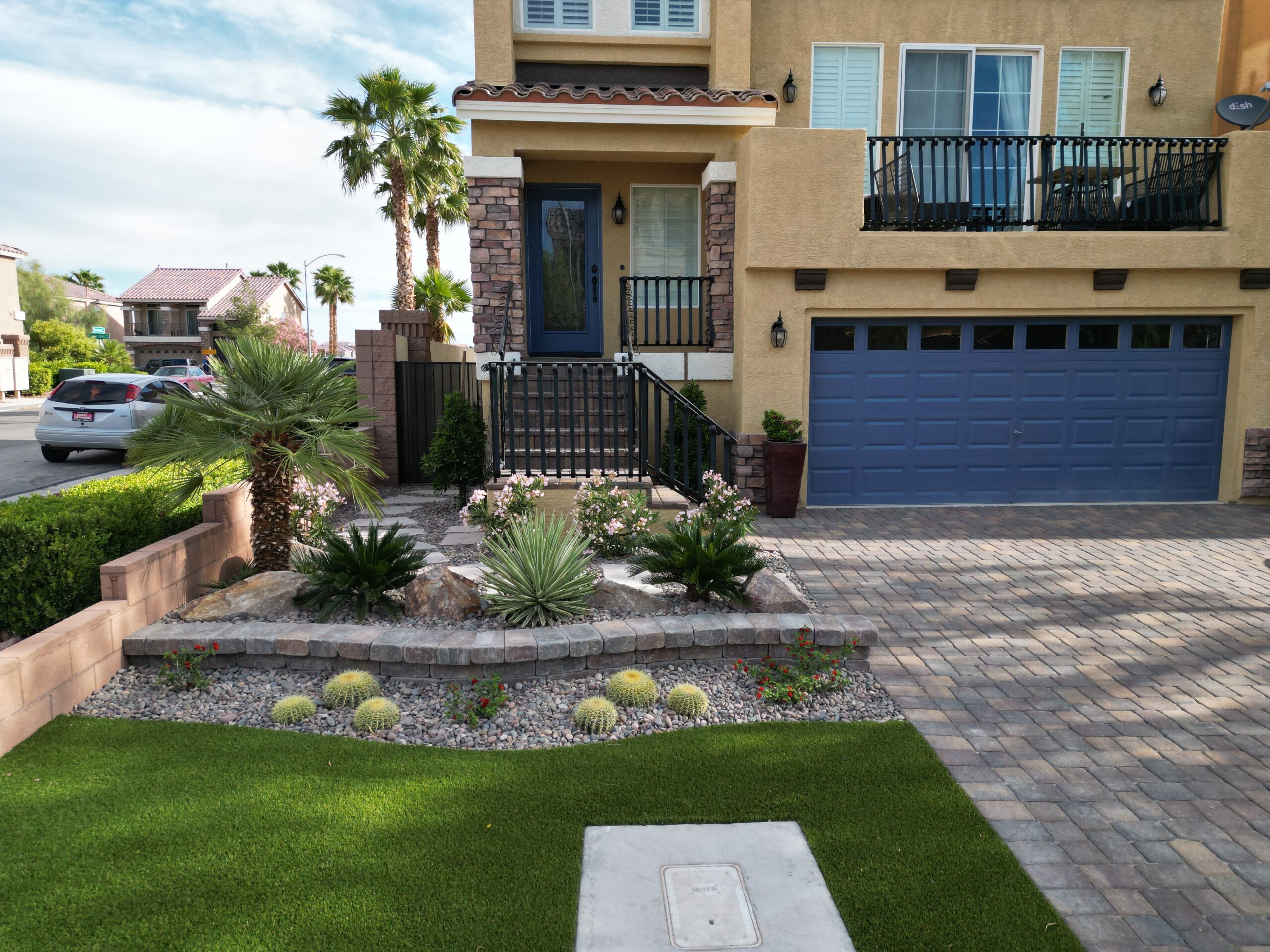 A house with a driveway and lawn in front of it. A house with a driveway and lawn in front of it.