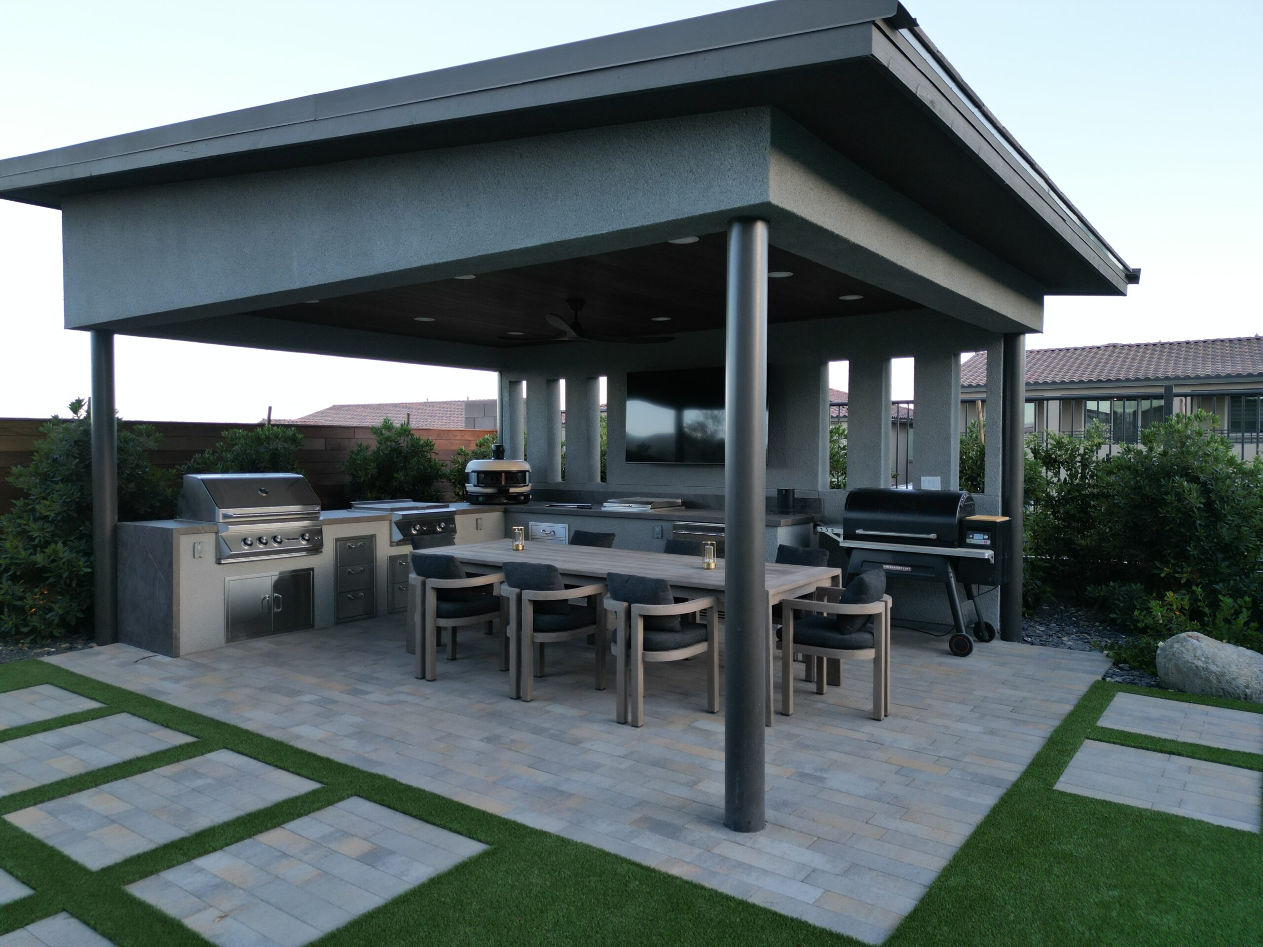 A patio with an outdoor grill and table A patio with an outdoor grill and table
