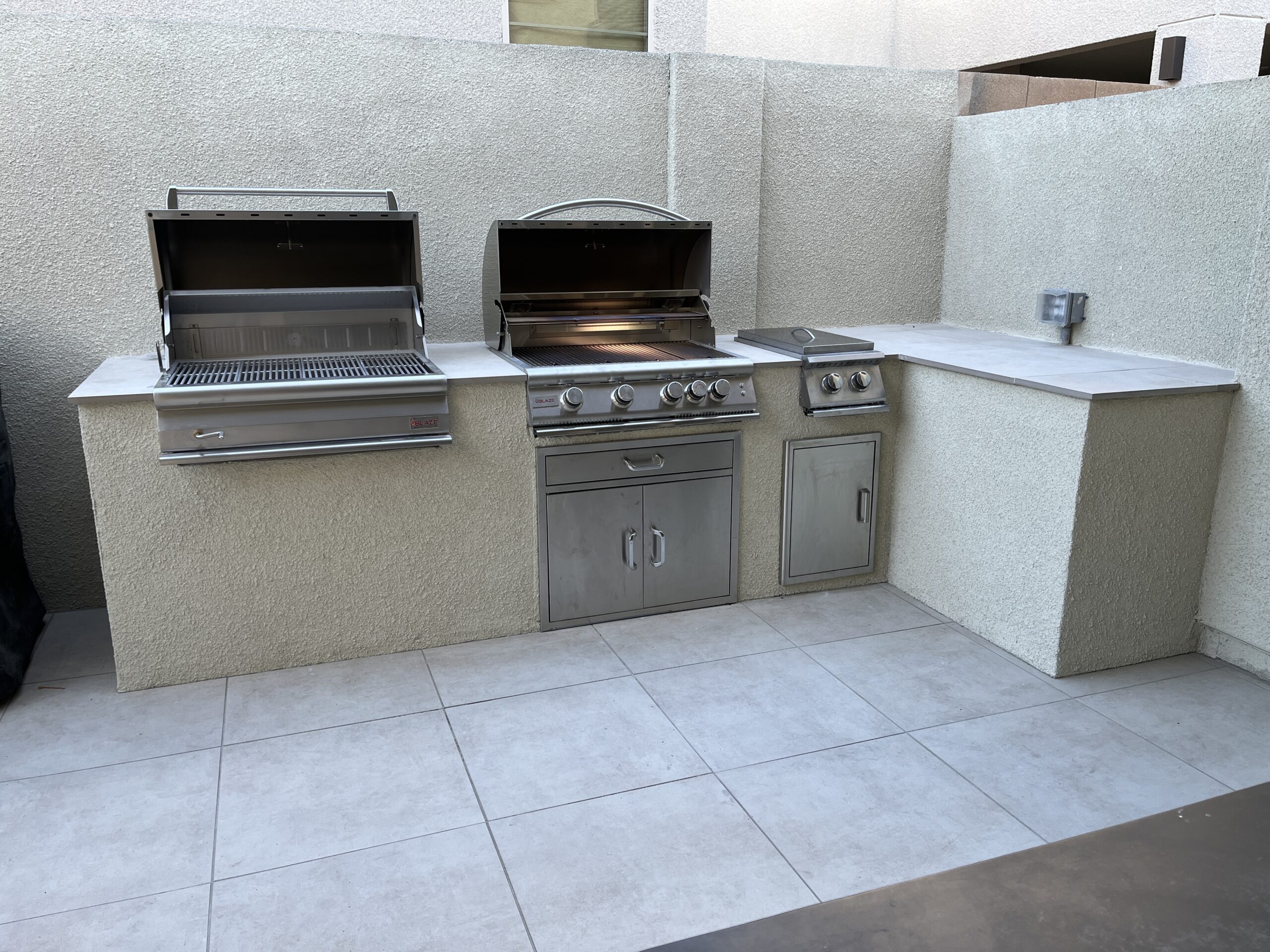 A large outdoor grill and sink in an outside kitchen. A large outdoor grill and sink in an outside kitchen.
