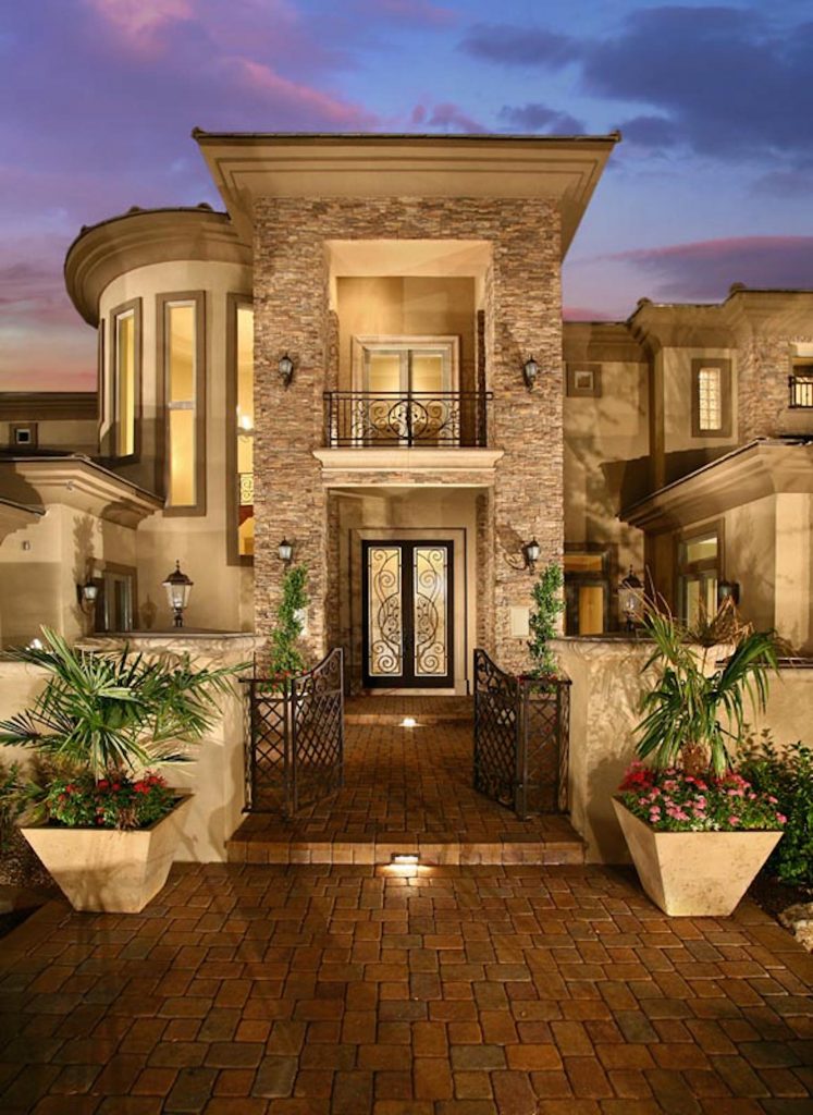 A large house with potted plants and lights A large house with potted plants and lights