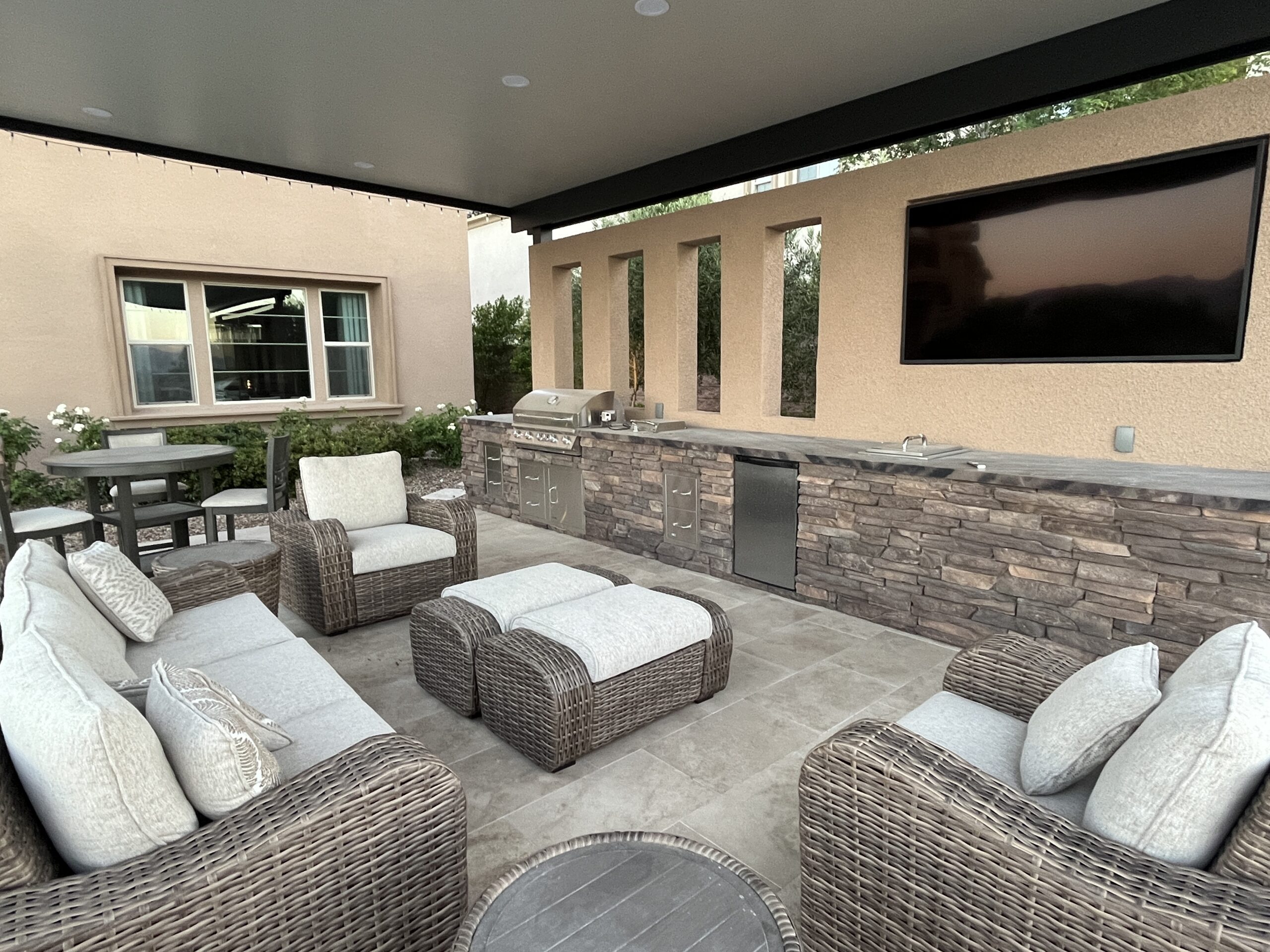 A patio with couches and chairs, television on the wall. A patio with couches and chairs, television on the wall.